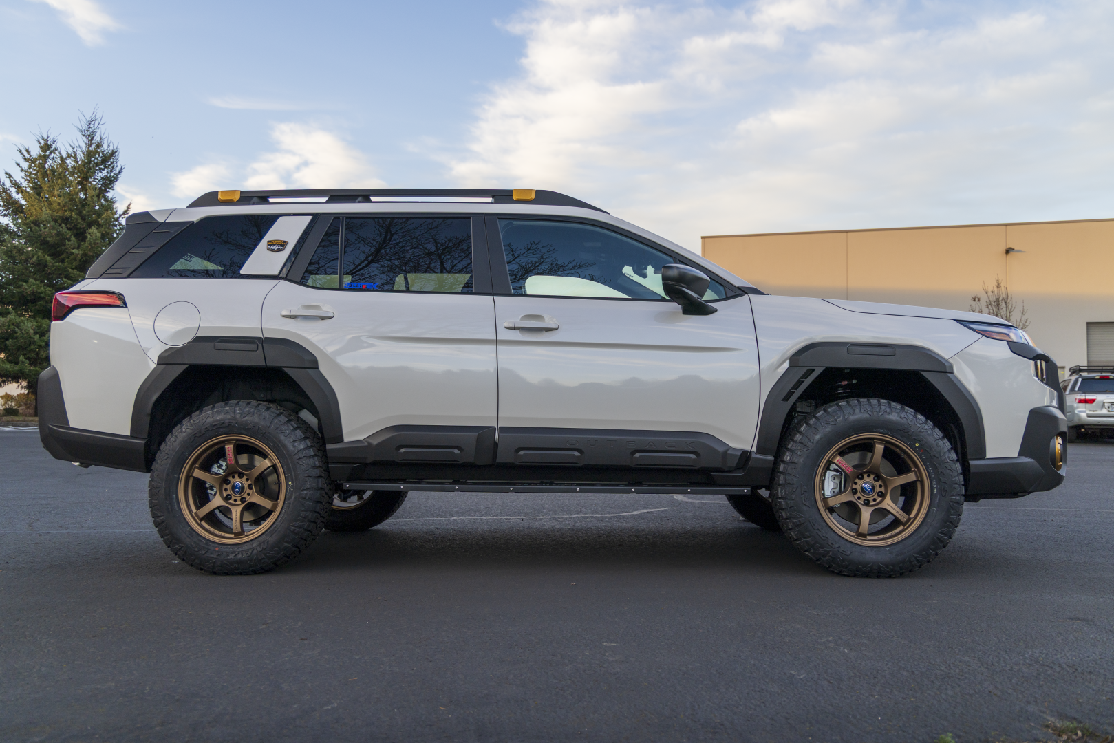 2026 Outback Wilderness Lifted Side View with RalliTEK Rock Sliders