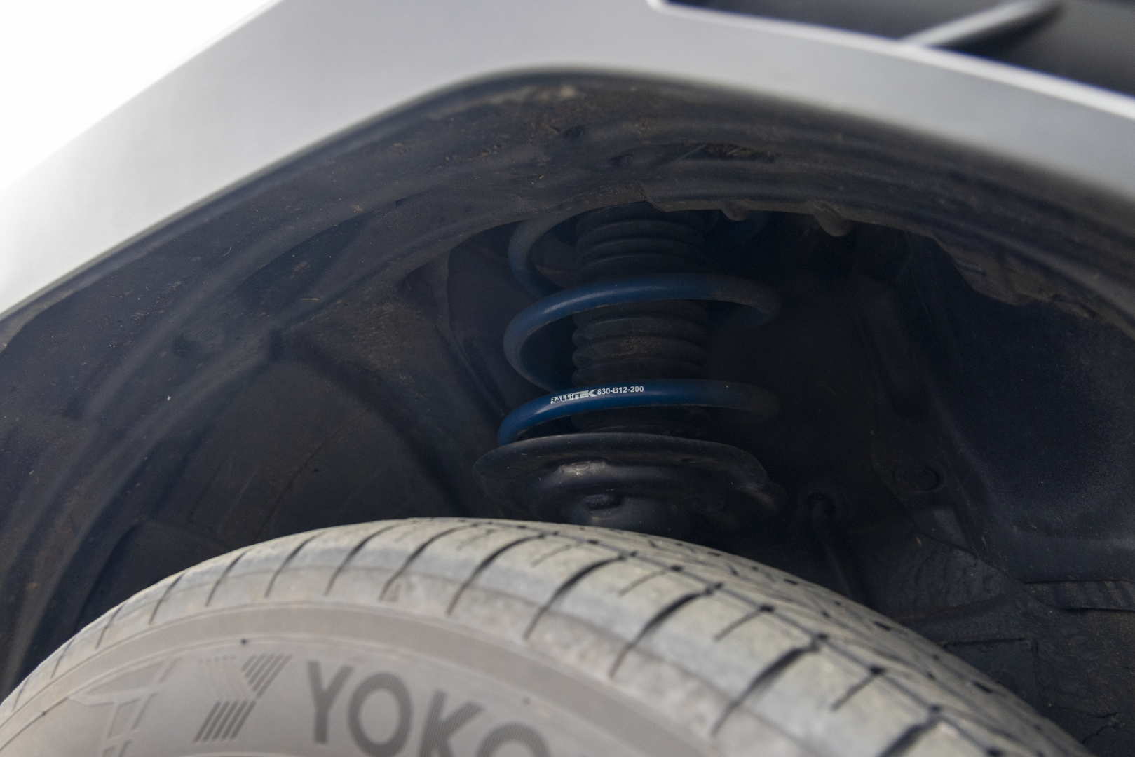 Close-up of a spring installed with RalliTEK branding, focusing on the spring installed on the strut assembly