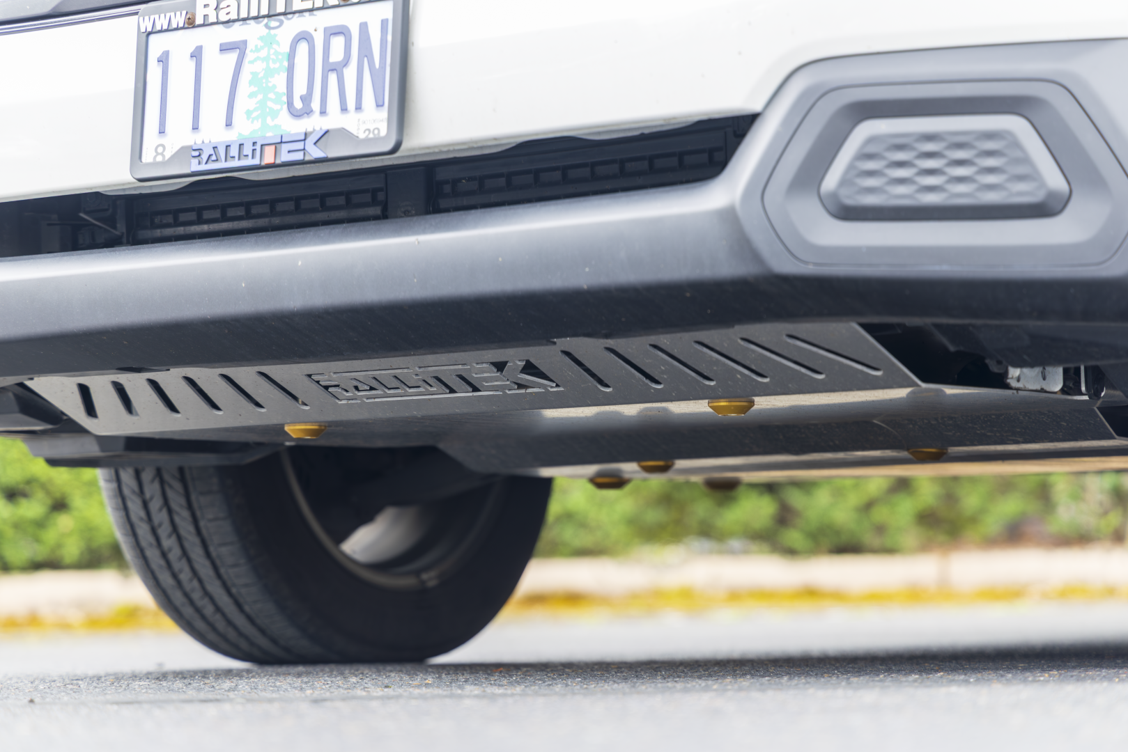 2025 Forester Front Skid Plate Installed on vehicle with gold dome washers
