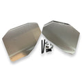 A pair of silver aluminum gas tank skid plates with mounting hardware laid out on a white background.