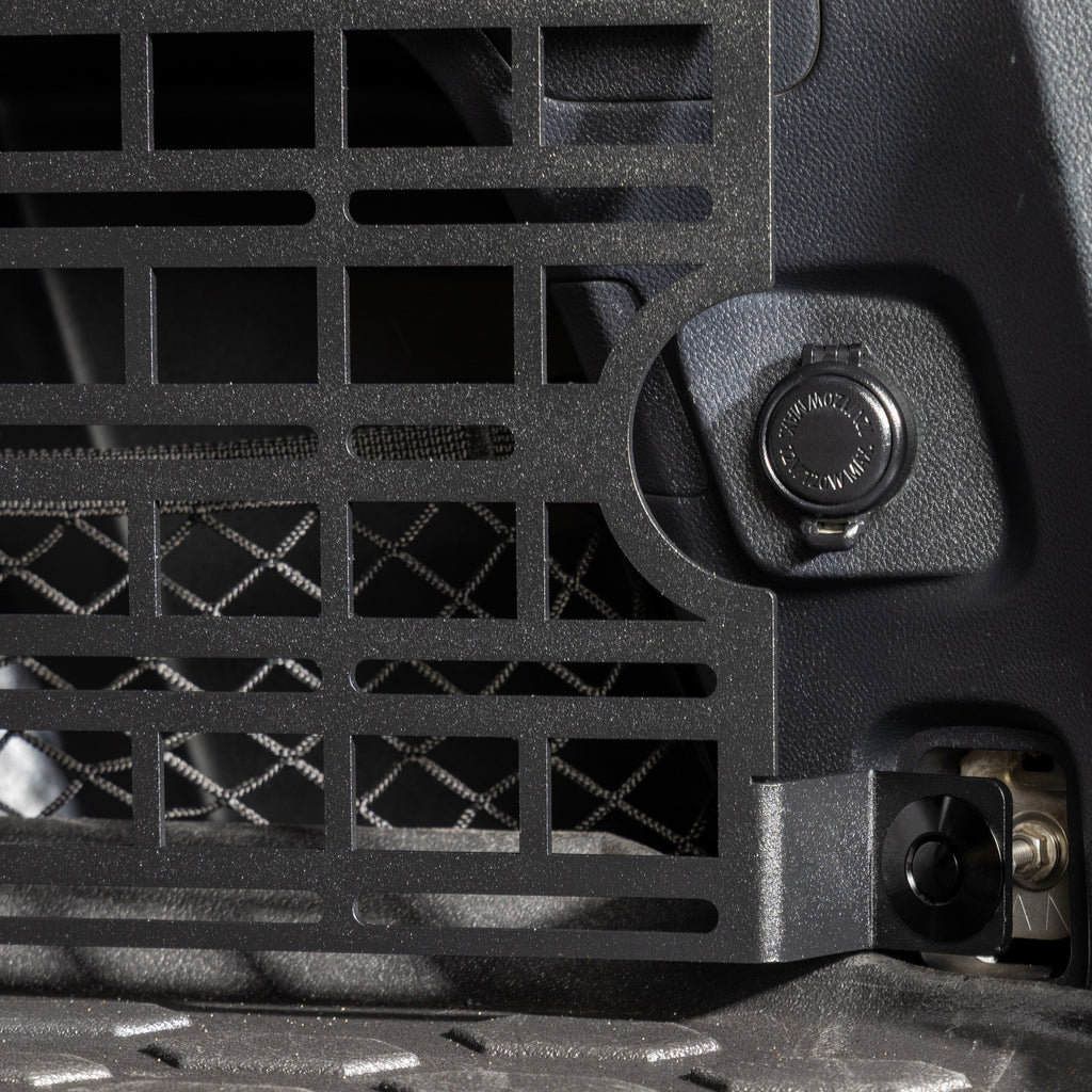 subaru outback molle panel installed in rear cargo storage area closeup of cutout for 12v accessory plug