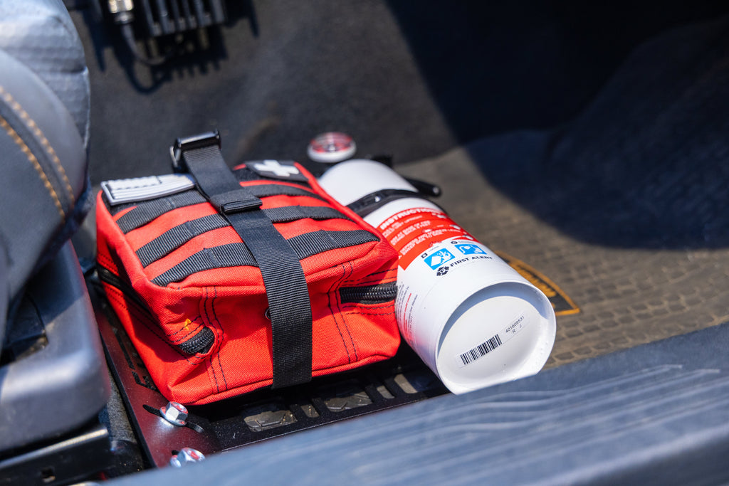 Red molle bag and white fire extinguisher attached to Rallitek seat bracket fire extinguisher mount
